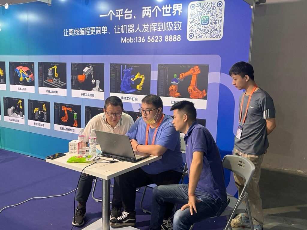 A group of people observes a presentation on a laptop screen.