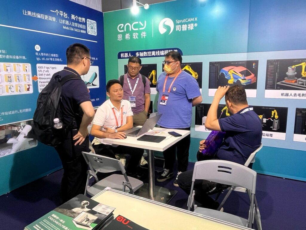 A group of people engage in discussion at a conference booth.