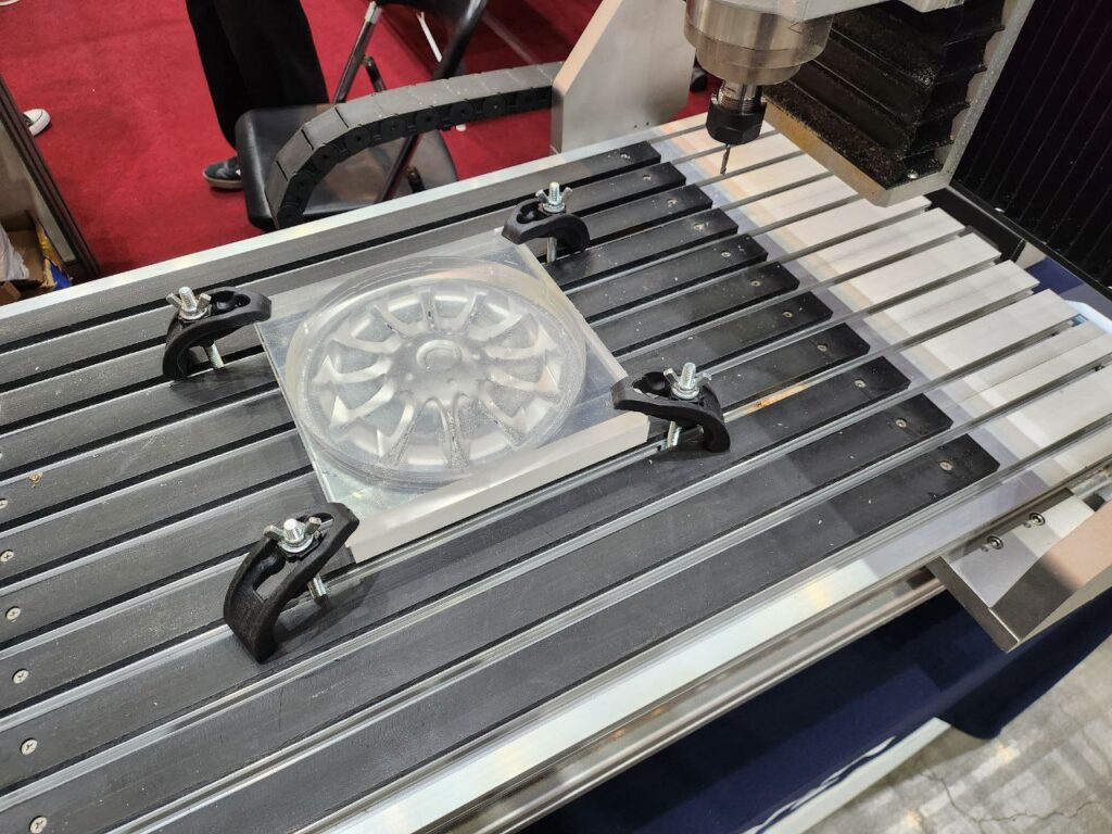 A CNC machine is engraving a detailed design on a material.