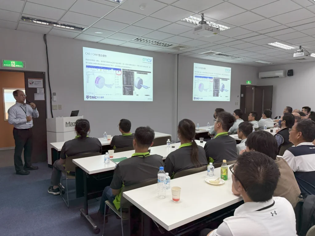 A group of people attentively listens to a presentation in a meeting room.