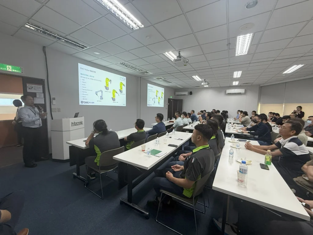 A group of people attentively listens to a presentation in a conference room.