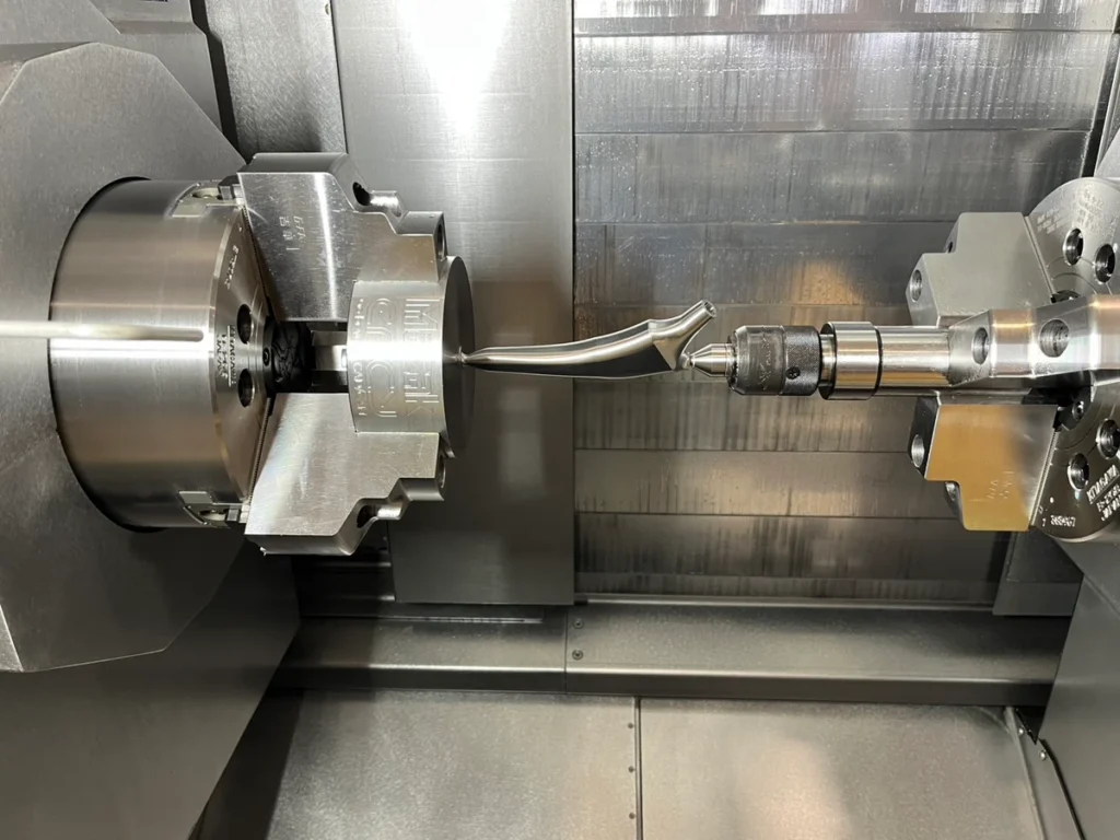 A close-up of a lathe machining a metal part with precision.