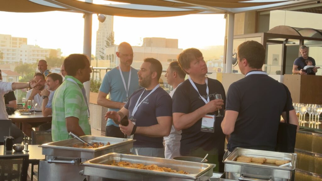 A group of people interacts while enjoying food at an outdoor event.