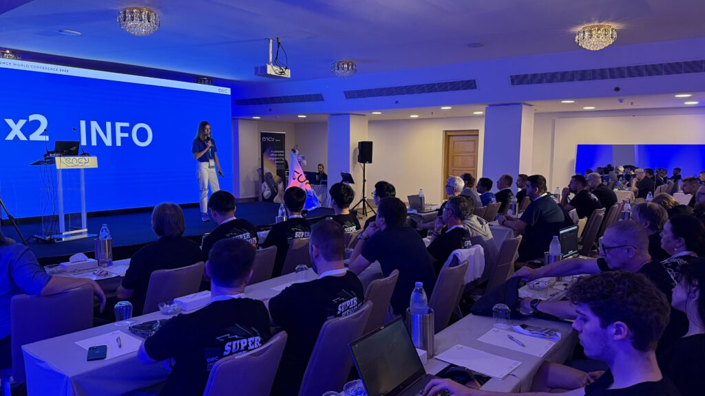 A presenter engages an audience during a conference session.