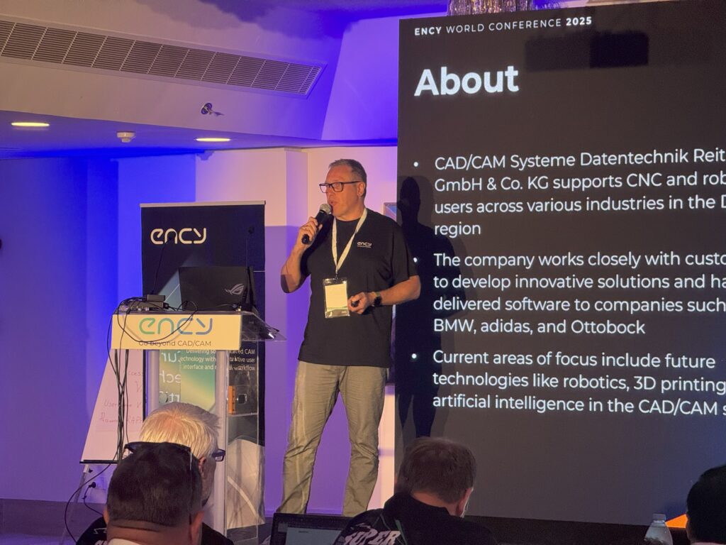 A speaker presents about CADCAM Systems at the conference.
