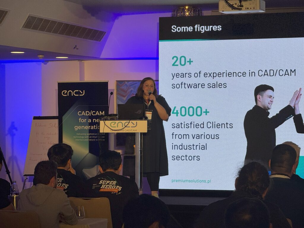 A speaker presents statistics on software sales to an audience.