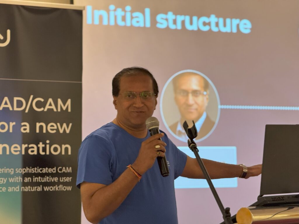 A speaker presents an initial structure during a conference.