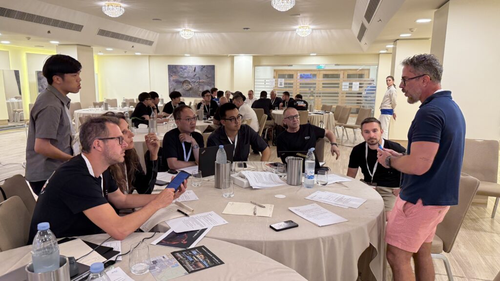 Participants engage in a collaborative discussion around a table.