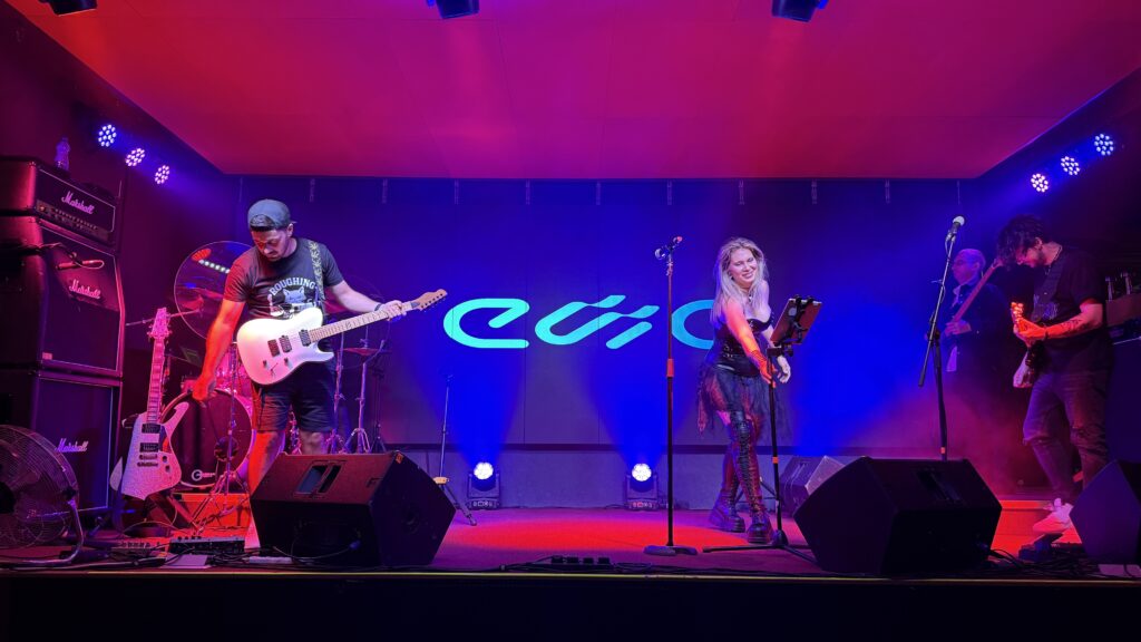 A musician performs on stage while another plays guitar.