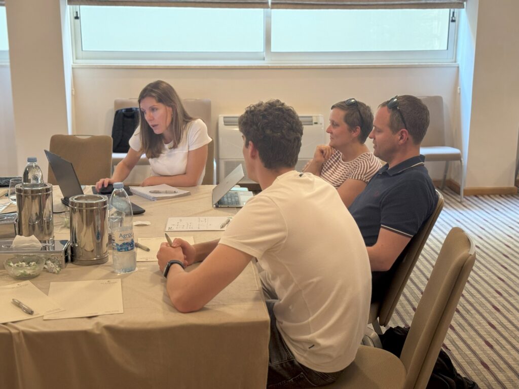 A group of people engaged in a discussion around a table.