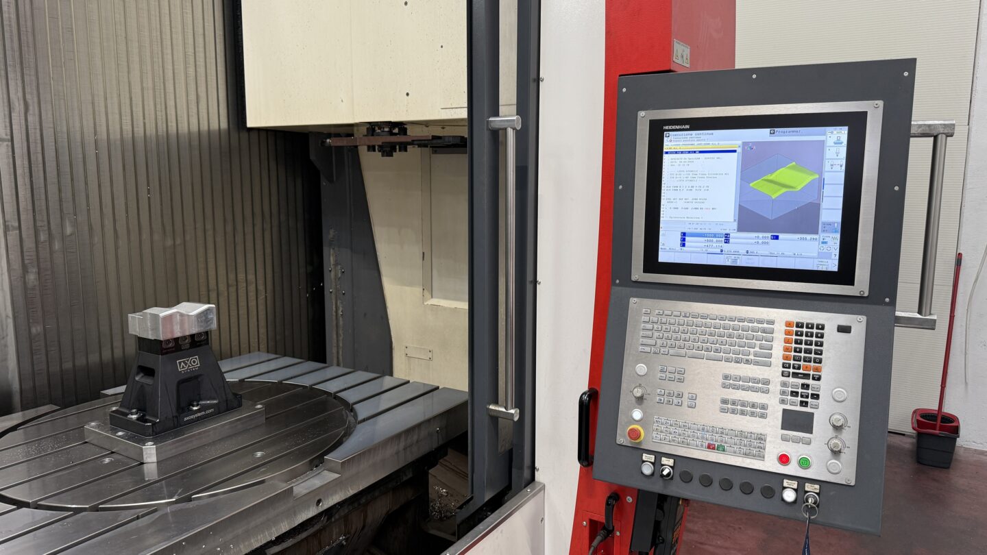 A CNC machine with a digital control panel is ready for operation.