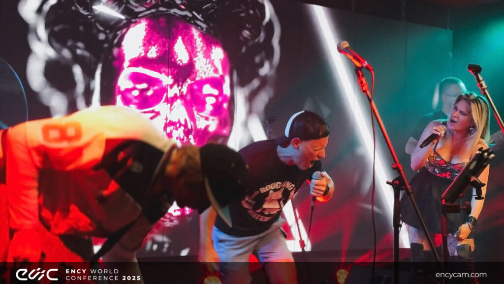 A performer passionately sings into a microphone on stage.