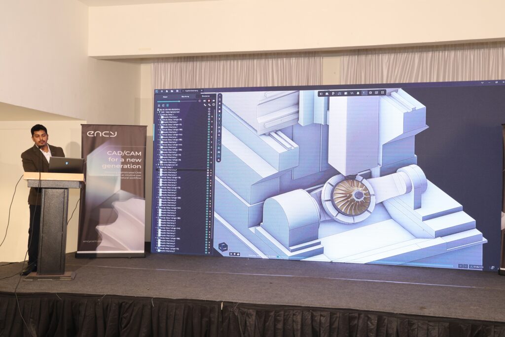 A large digital display shows a 3D architectural rendering.