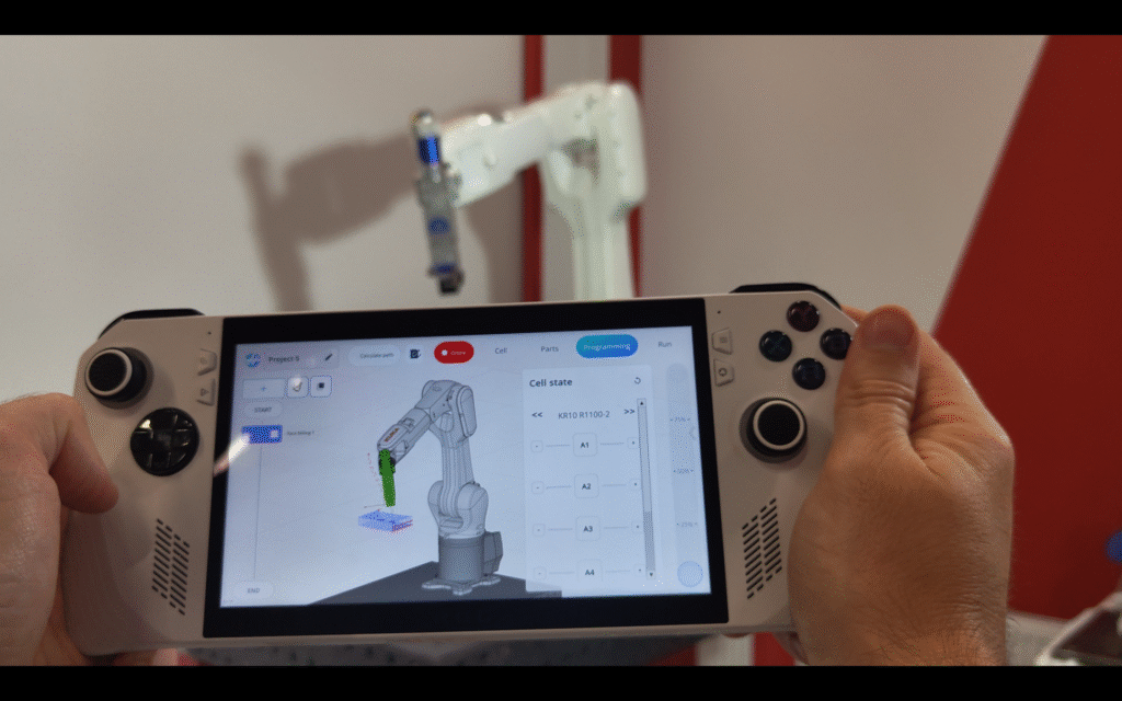 A person controls a robotic arm using a tablet interface.
