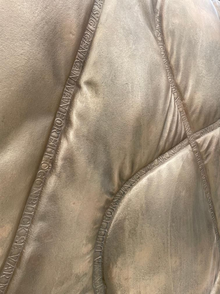 Stockholm memorial: a “soft blanket” of poetry — digital fabric cast in bronze