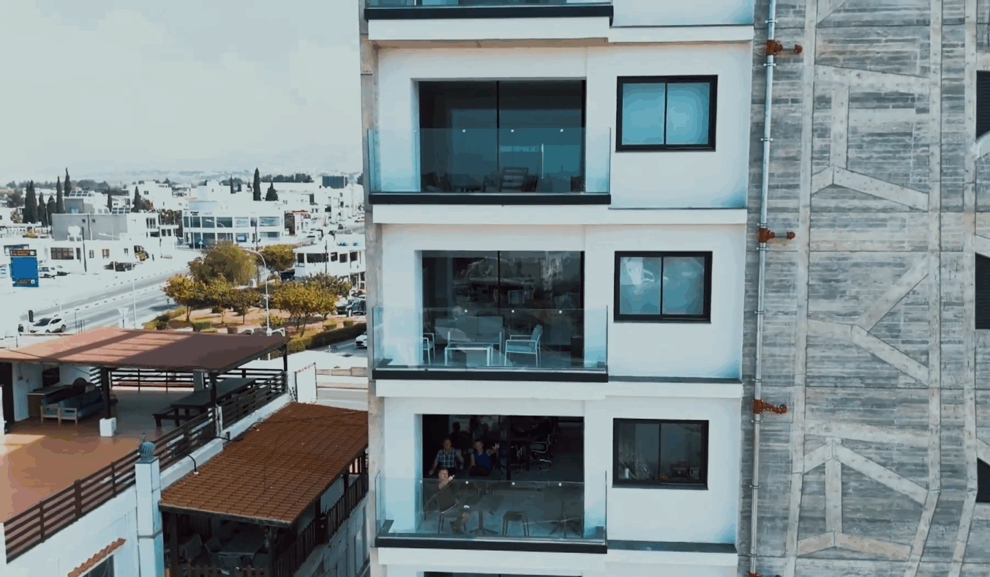 A modern building showcases various balconies and glass windows.