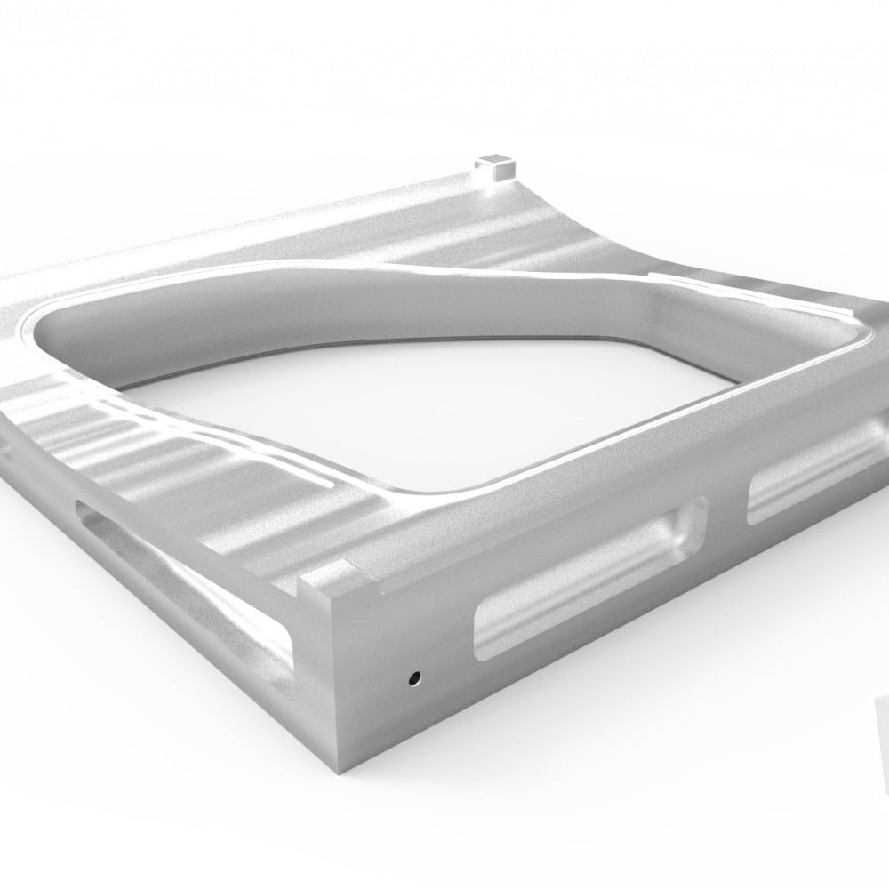 Rectangular aluminum workpiece with milled pockets and rounded internal corners, produced by CNC milling