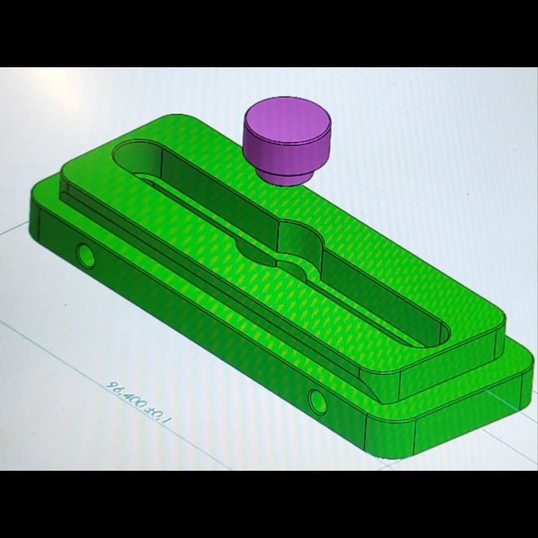 CAD/CAM simulation showing a metal block with a recessed slot being milled by a purple end-mill