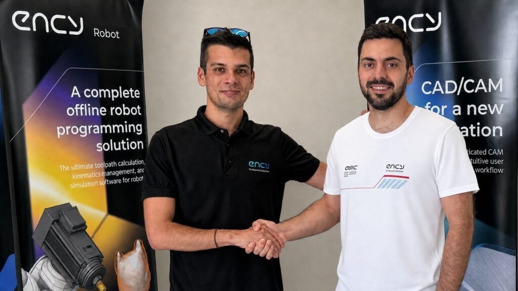 Andrei Kharatsidi and Vladimiros Tziortzis shake hands in front of ENCY Robot and ENCY CAD/CAM banners to mark the partnership ahead of the 2026 NASCAR Euro Series