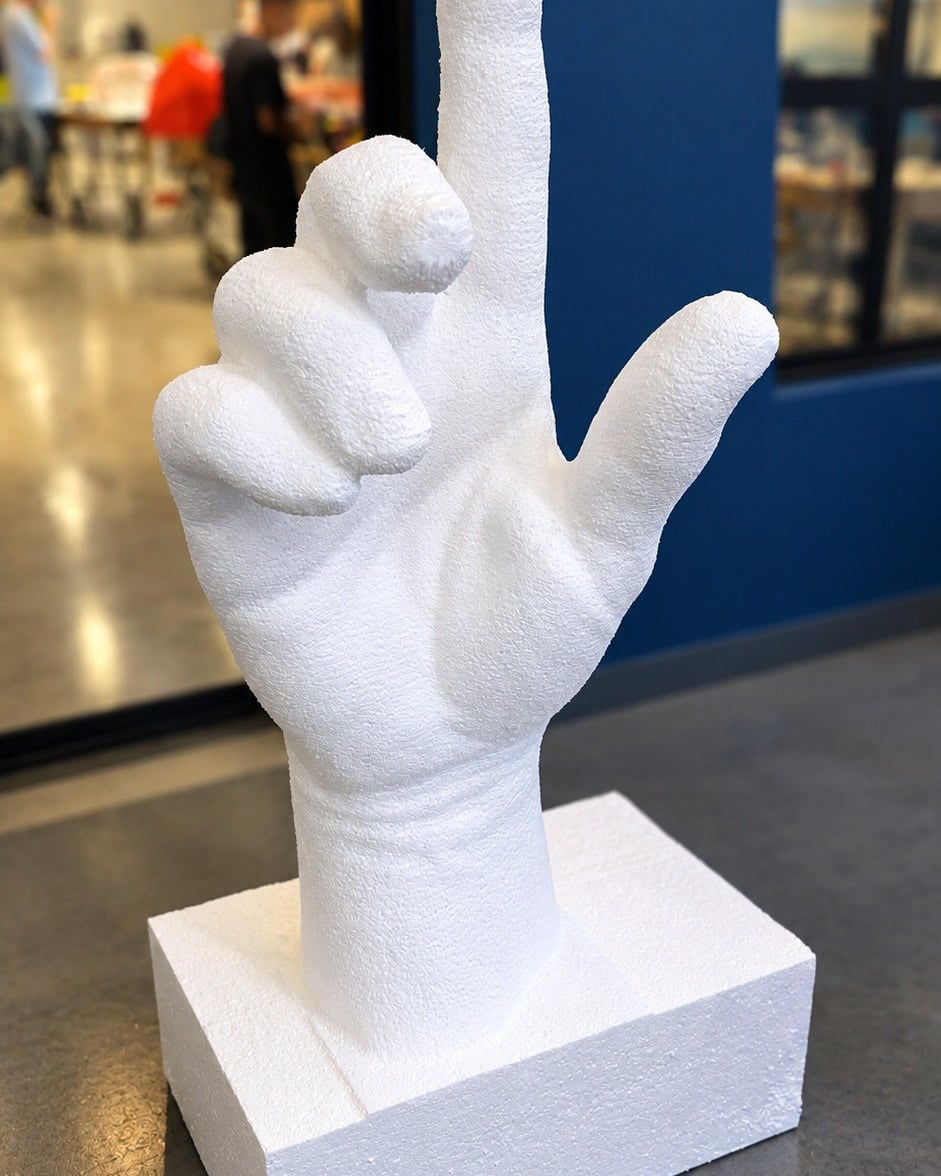 Finished one-metre EPS foam hand sculpture on a foam base, robot-milled from a 3D scan