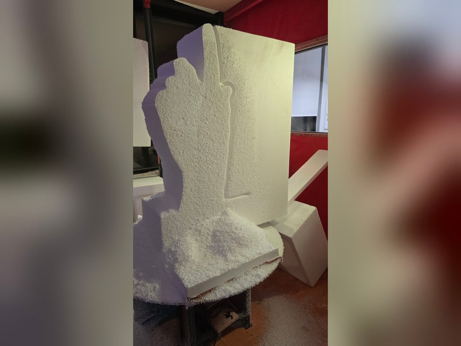 Roughed hand outline emerging from a polystyrene foam block