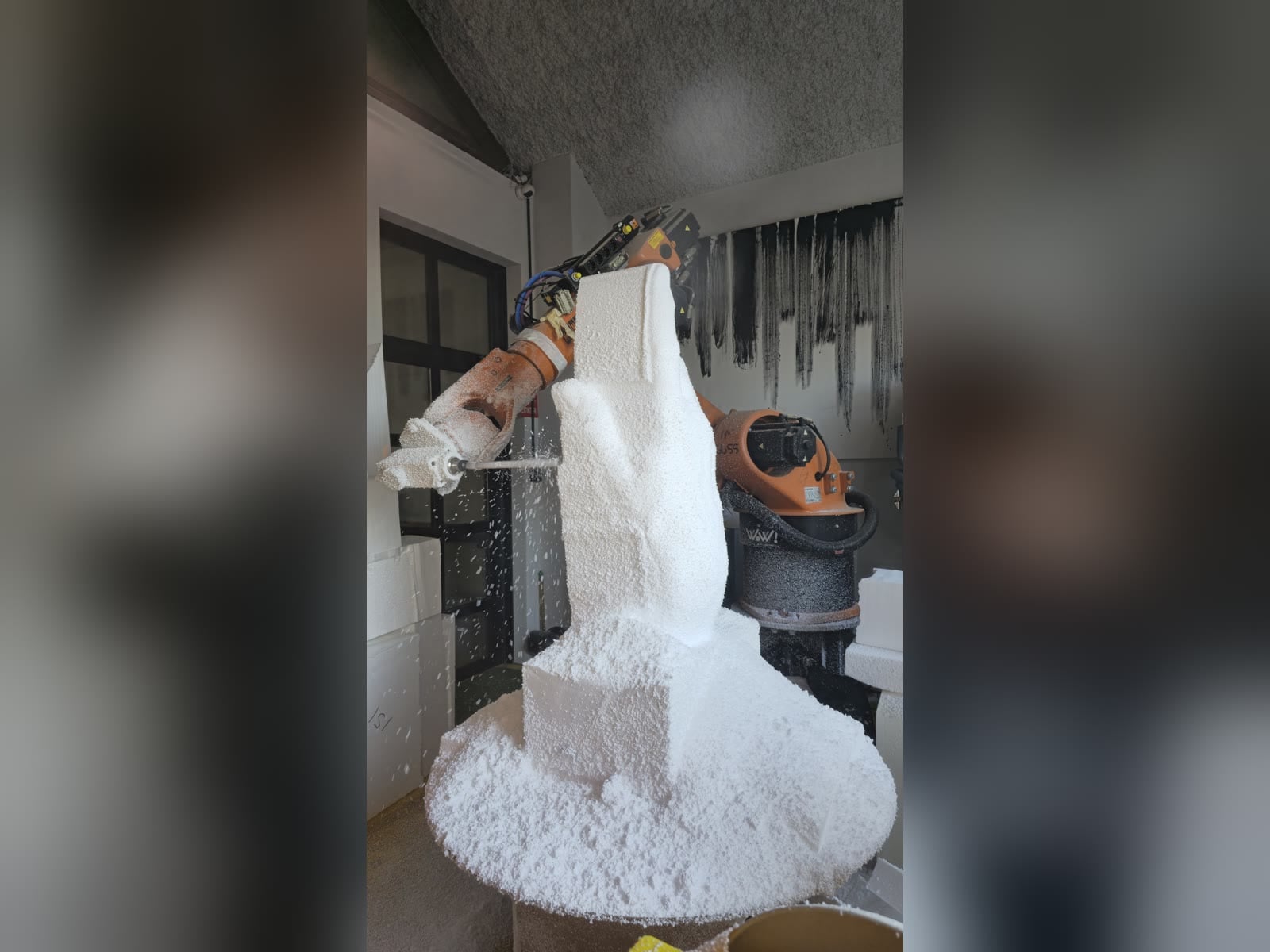 KUKA robot with spindle milling a foam hand on a rotary table