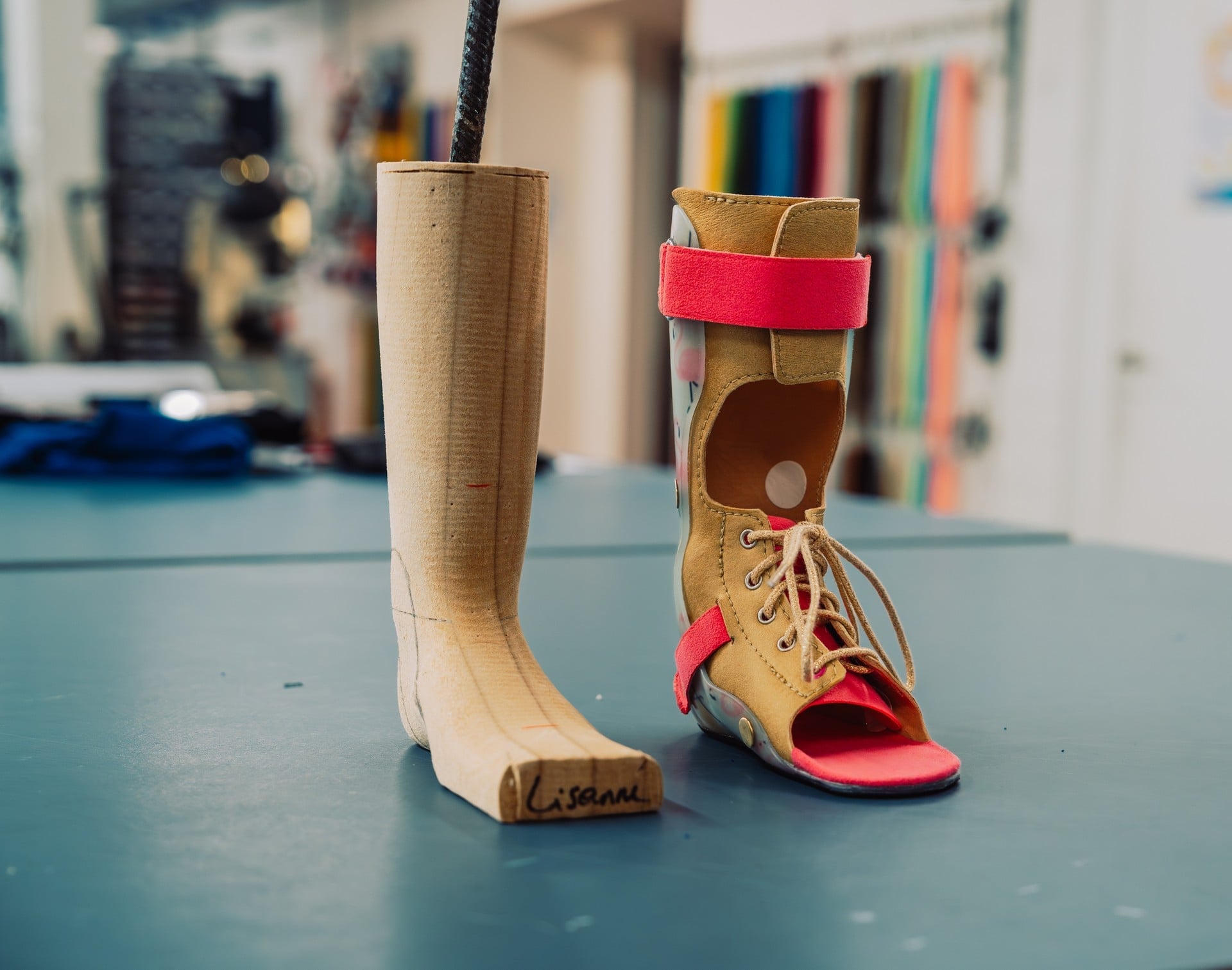 Milled leg model standing beside a finished custom ankle-foot orthosis