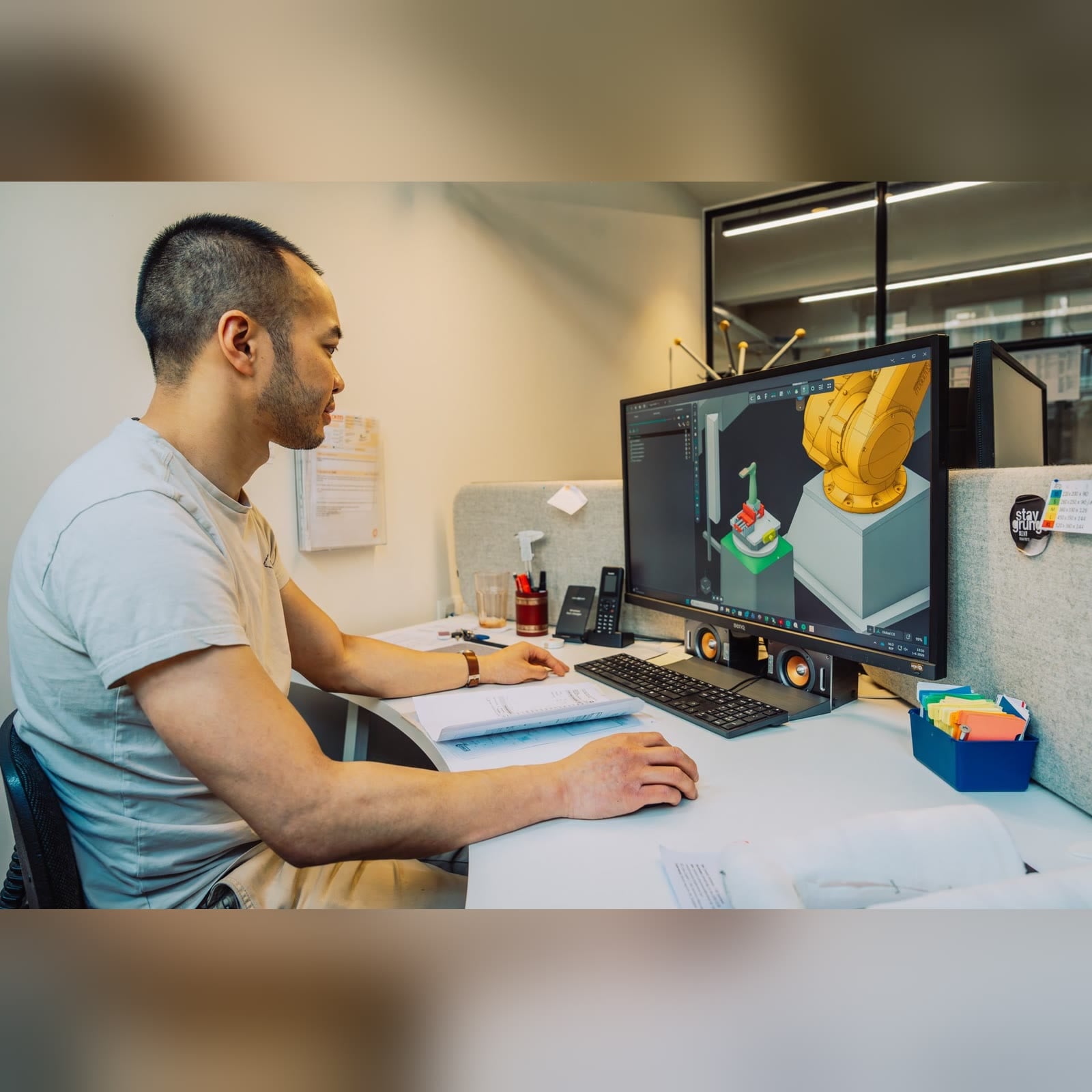 Specialist at a desk preparing a robotic milling project on screen