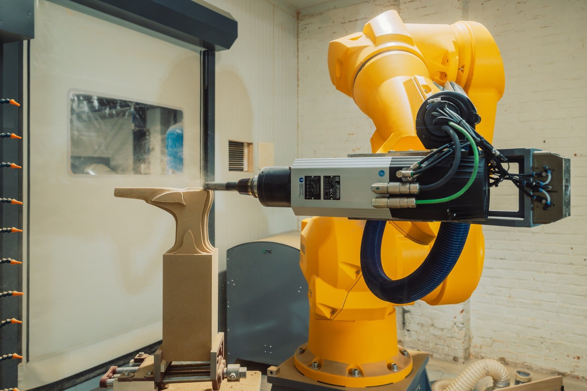 Yellow Stäubli TX200 robot with spindle milling an orthotic foot mold