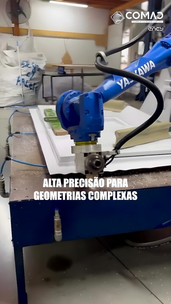 A Yaskawa six-axis robotic arm with a CNC milling spindle routing a white composite panel on a worktable