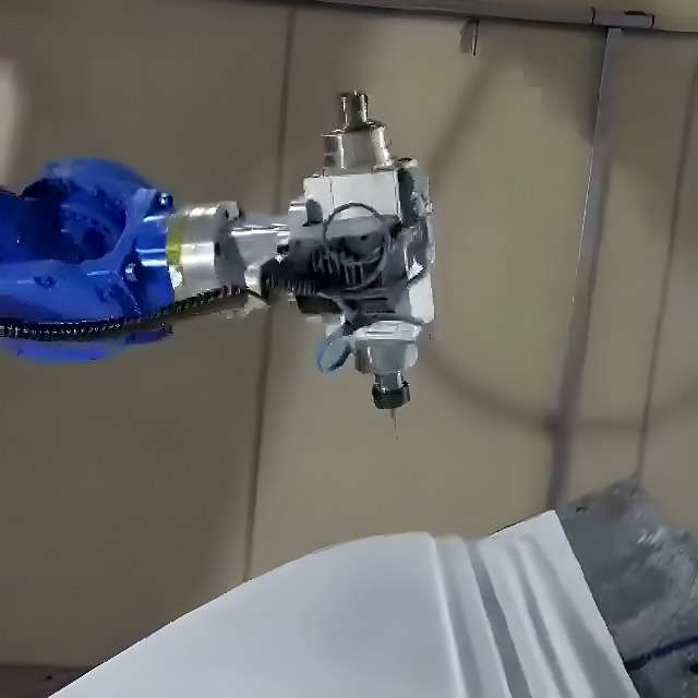 Blue industrial robot arm with CNC spindle milling a white prototype block