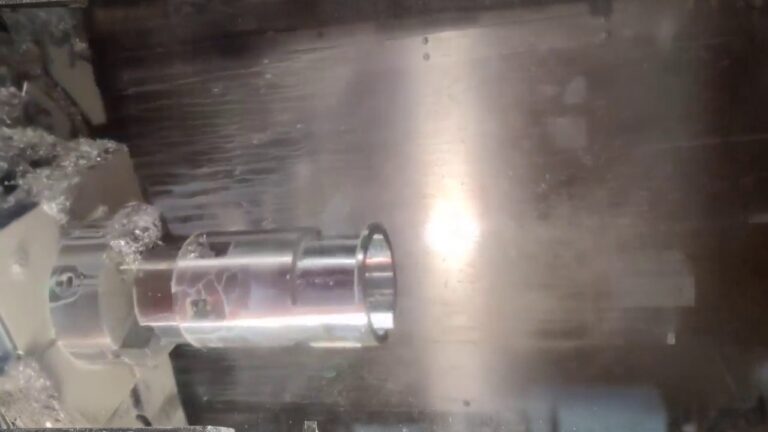 CNC lathe spindle holding a cylindrical metal blank during turning process