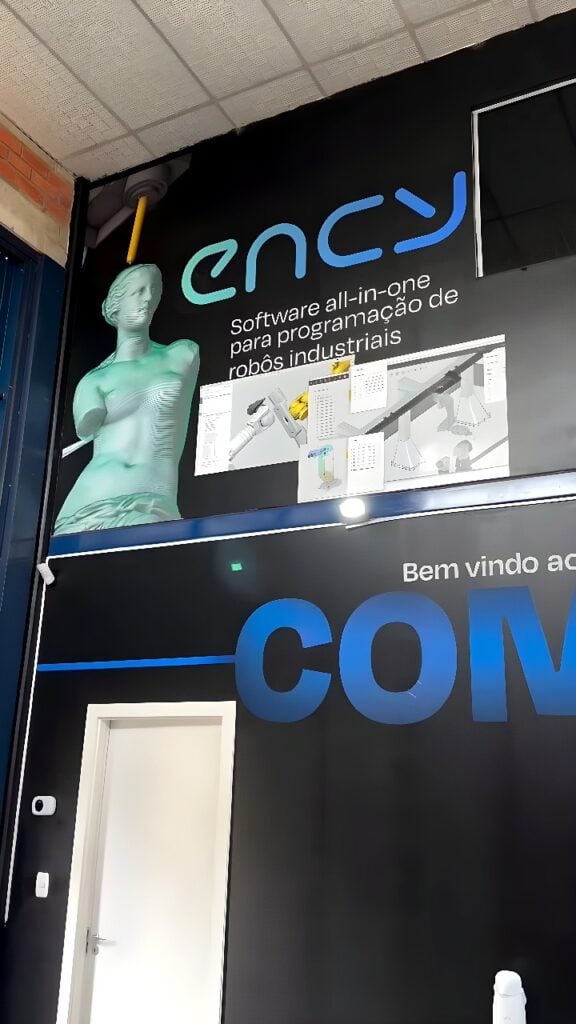 Six-axis industrial robot fitted with a milling spindle carving a wireframe bust in a robot programming and CAM simulation